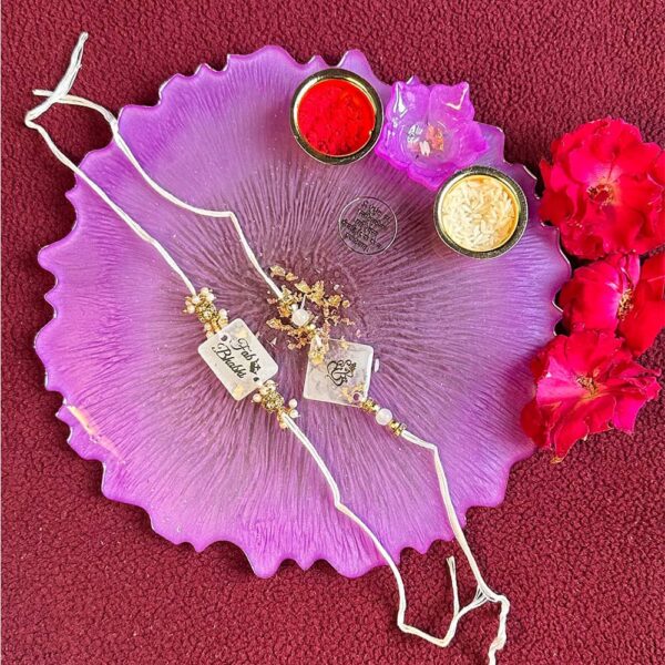 Pink Tilak thali with white couple Rakhi