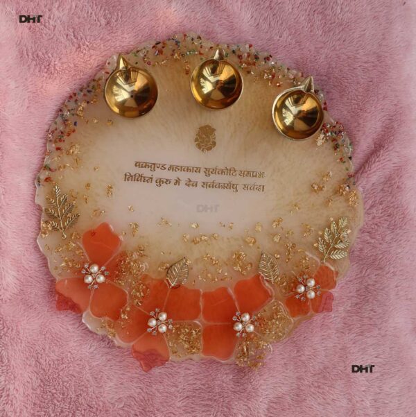 Resin made Aarti thali placed on pink surface